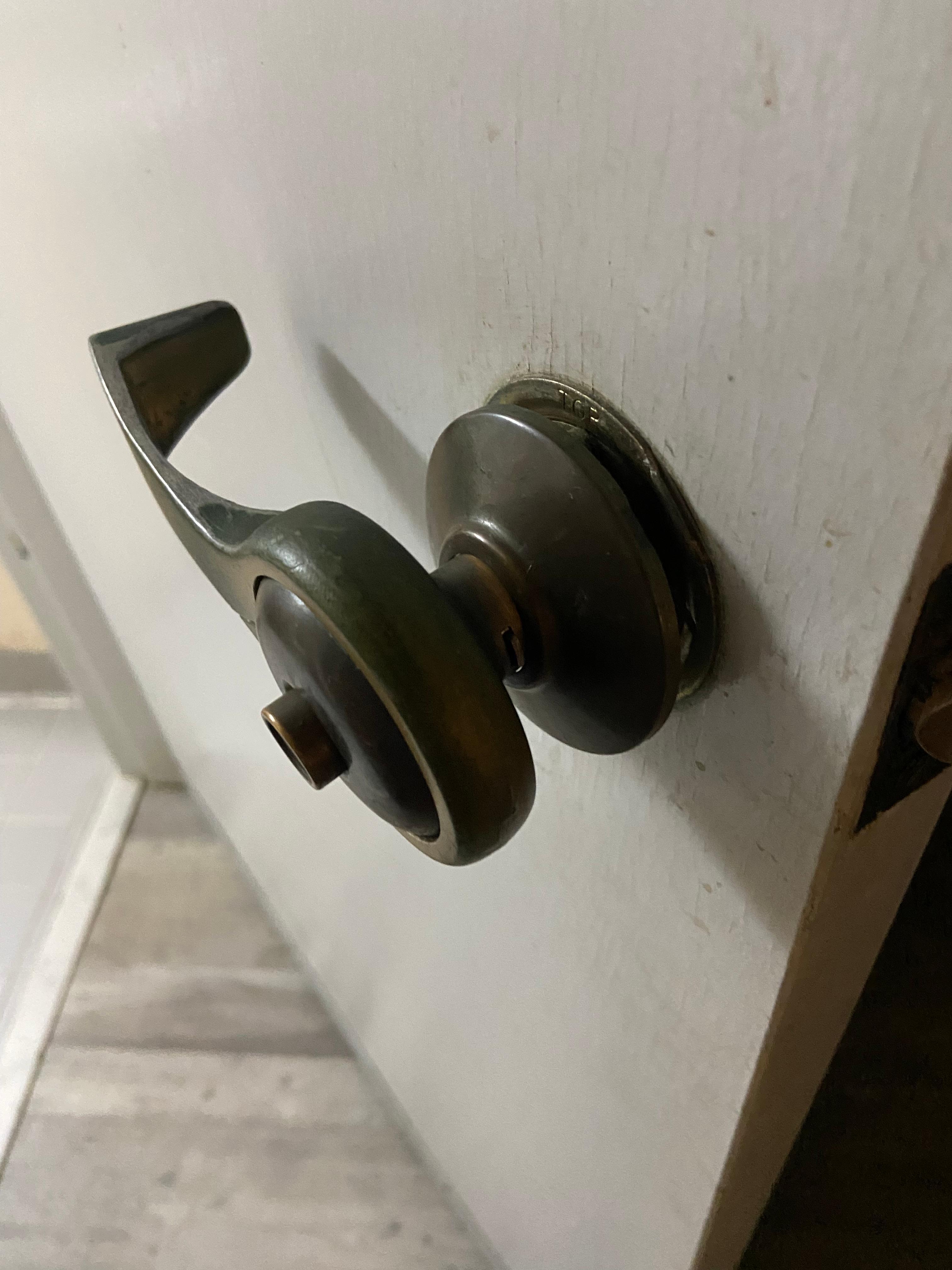 Loose bathroom door handle that was falling apart