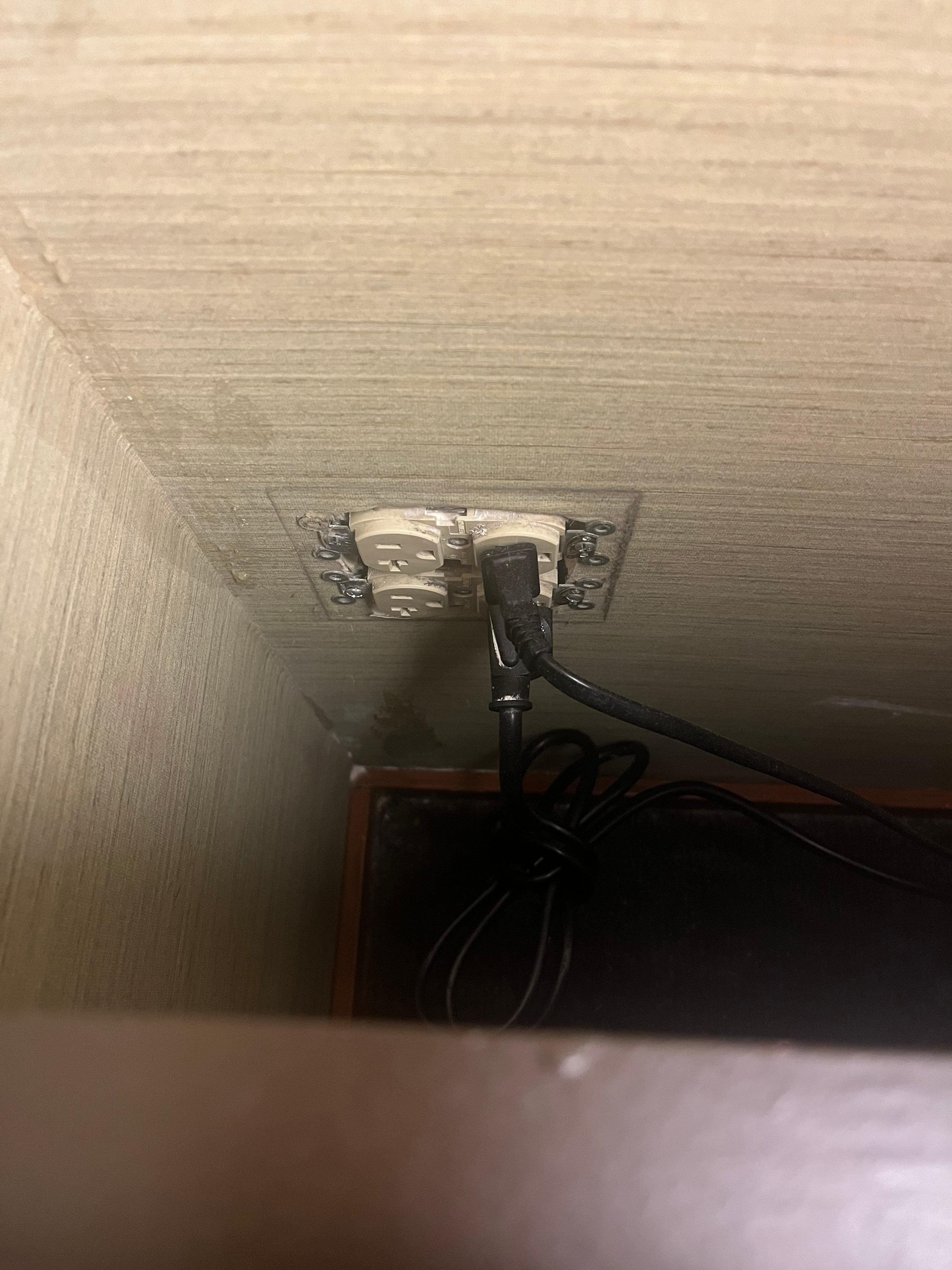 No cover on the outlet next to the bedframe