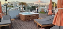 Terrace with hot tub and a number of sunbeds