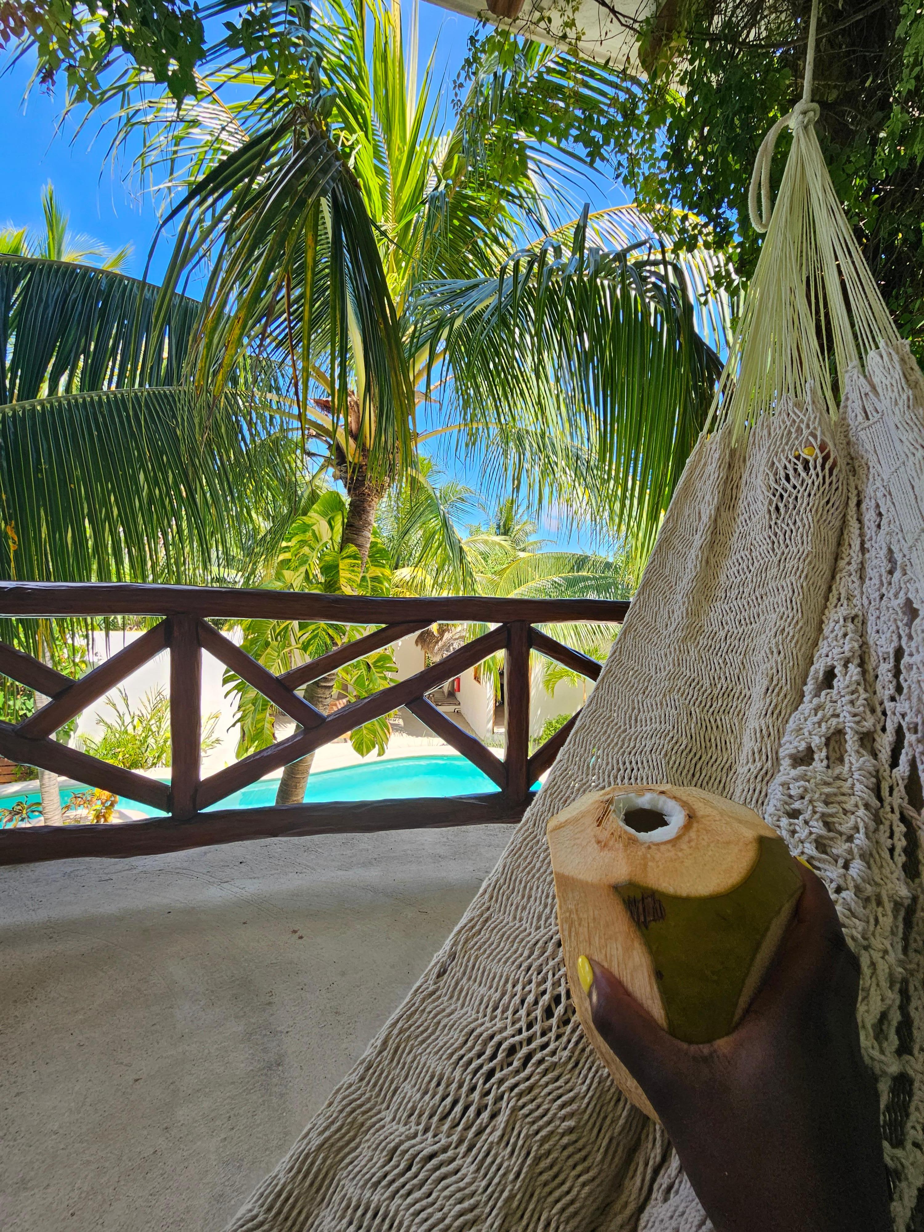 View of pool from hammock at balcony of Puerto room