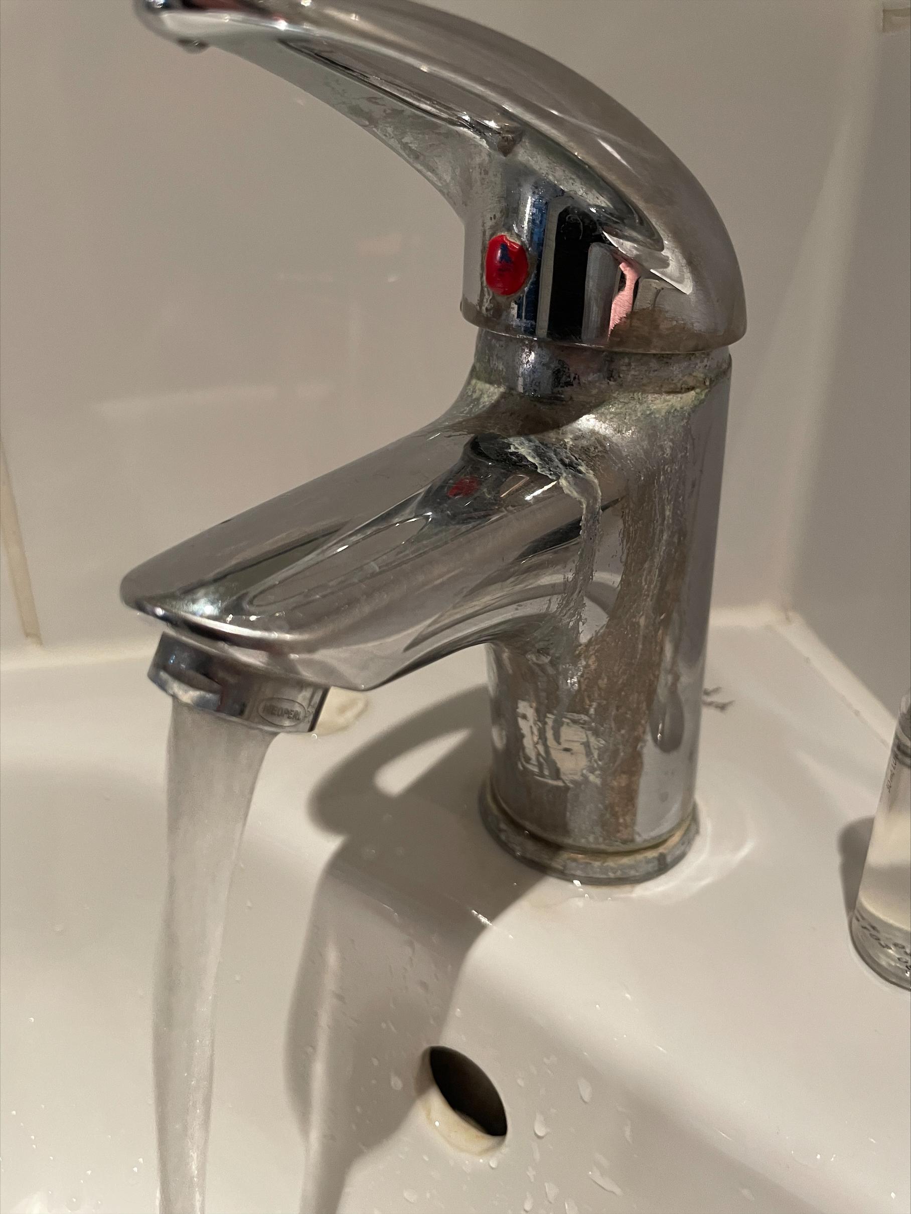 Water tap at the basin. Hand to turn the temprature.