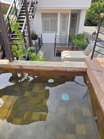 Dipping pool. I didn't dare put my face underwater. My room in background. The door to the right is another unit.