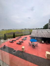 Indoor pool and patio looking into the bay.
