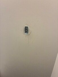 Scuffed up walls from the bed in the living room