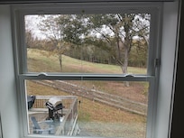Looking out window at the top of the stairs.
