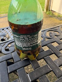 Cigarettes butts in bottle on patio table