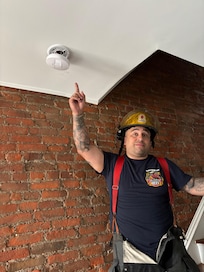 FD checking out the carbon monoxide alarm.