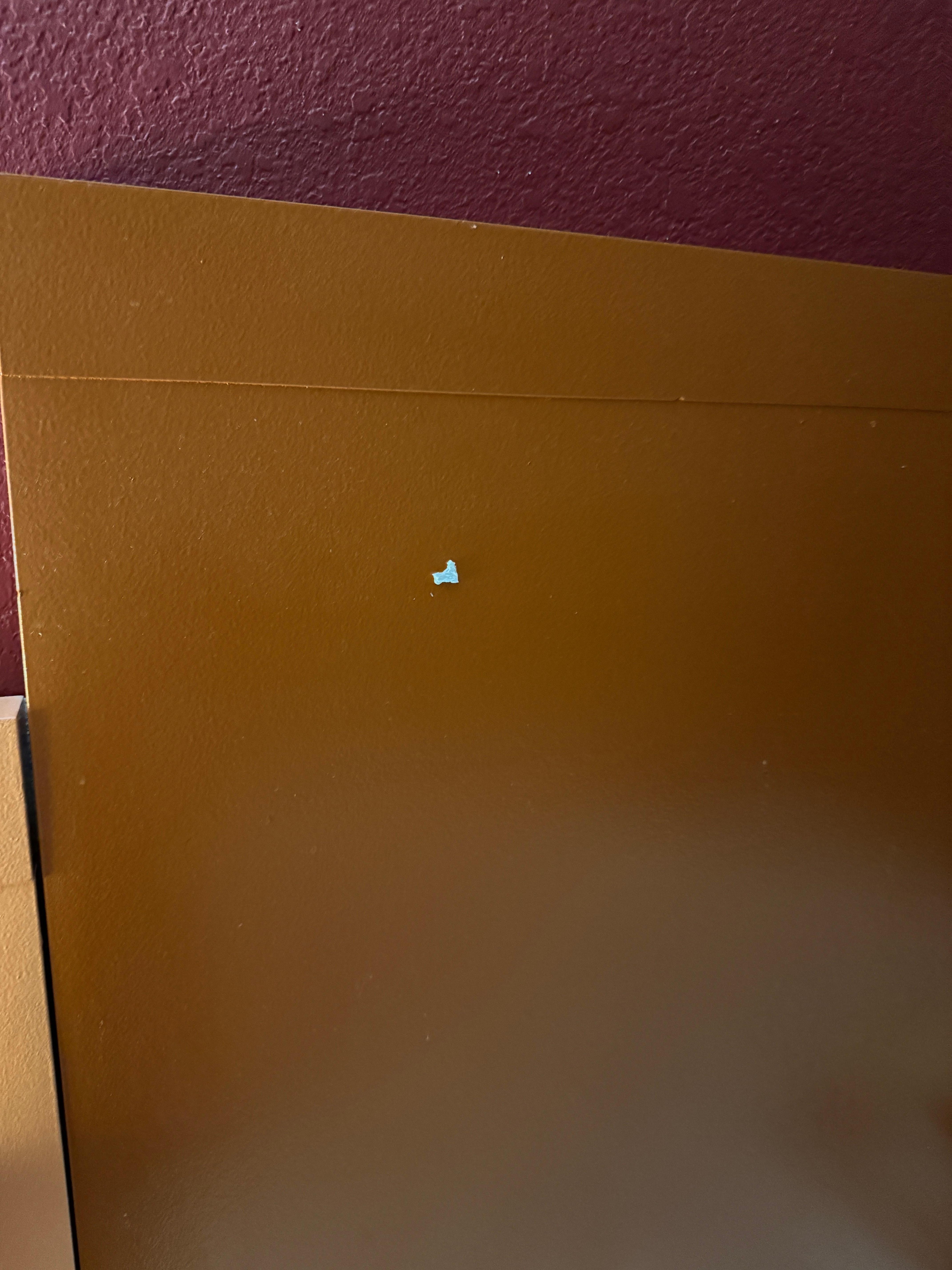 The headboard with two-sided tape stuck to it