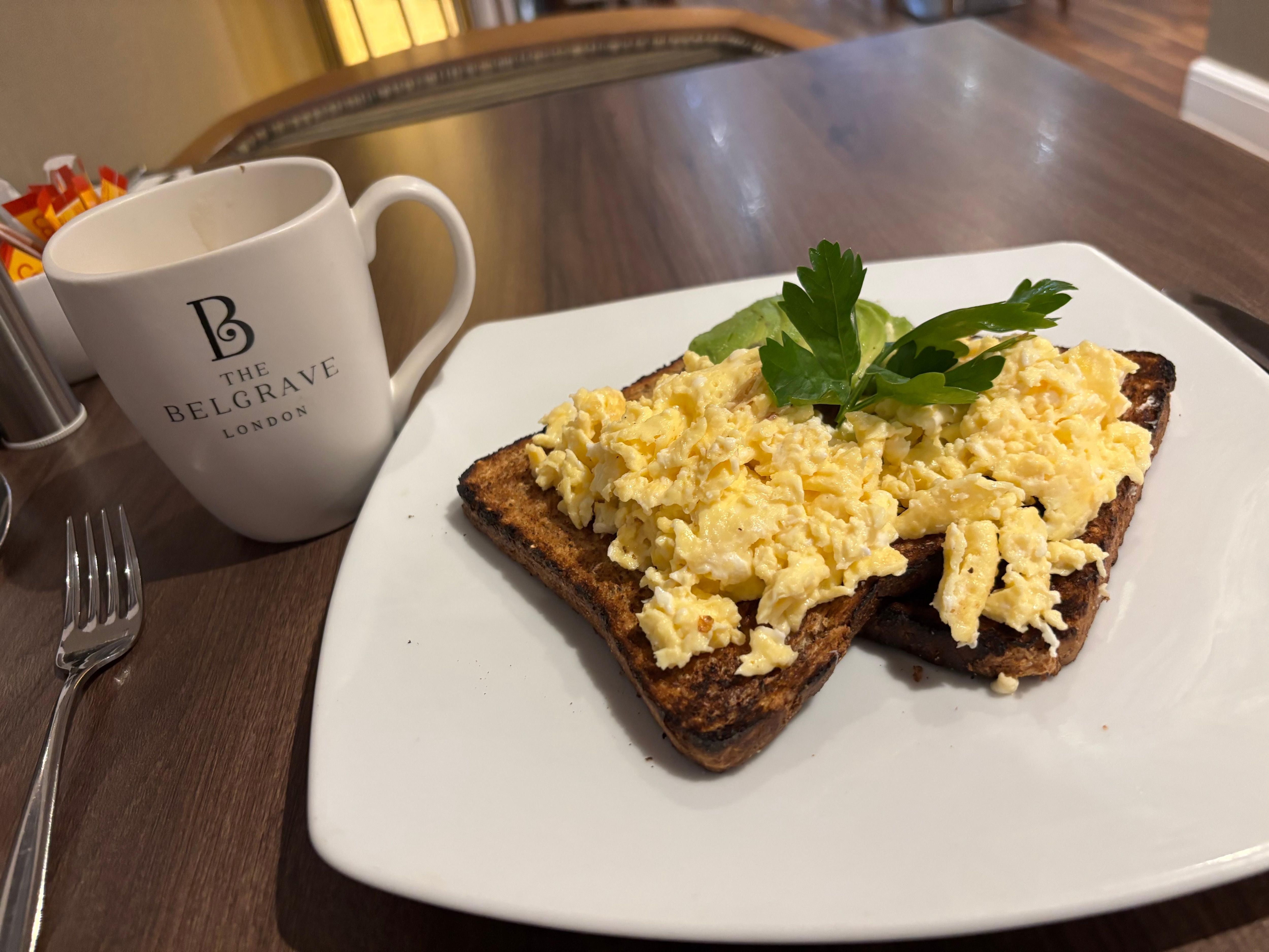 Scrambled egg on toast with avocado and coffee on the side!