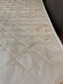 Dirty, marked ó stained with suspicious red marks on mattress