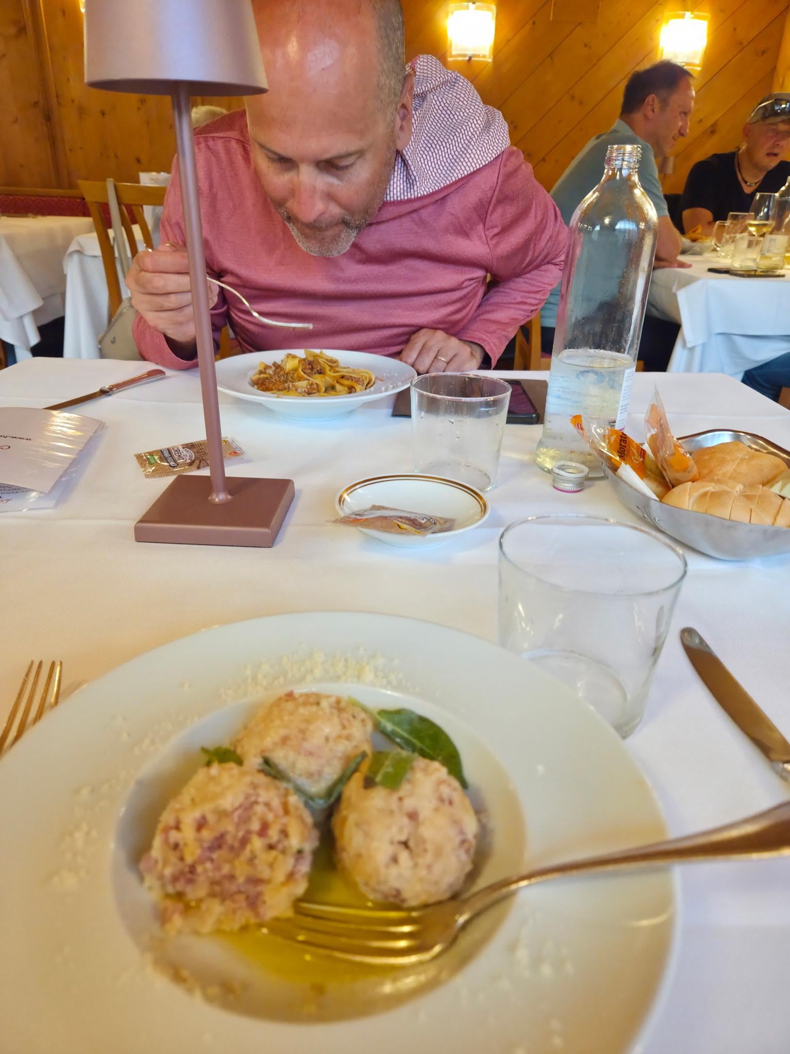 Tasting a local dish. It's like a stuffing ball with smoked pork. Delicious!