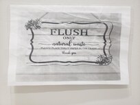 A sign requesting toilet paper not be flushed in the toilet - unsanitary and unacceptable!