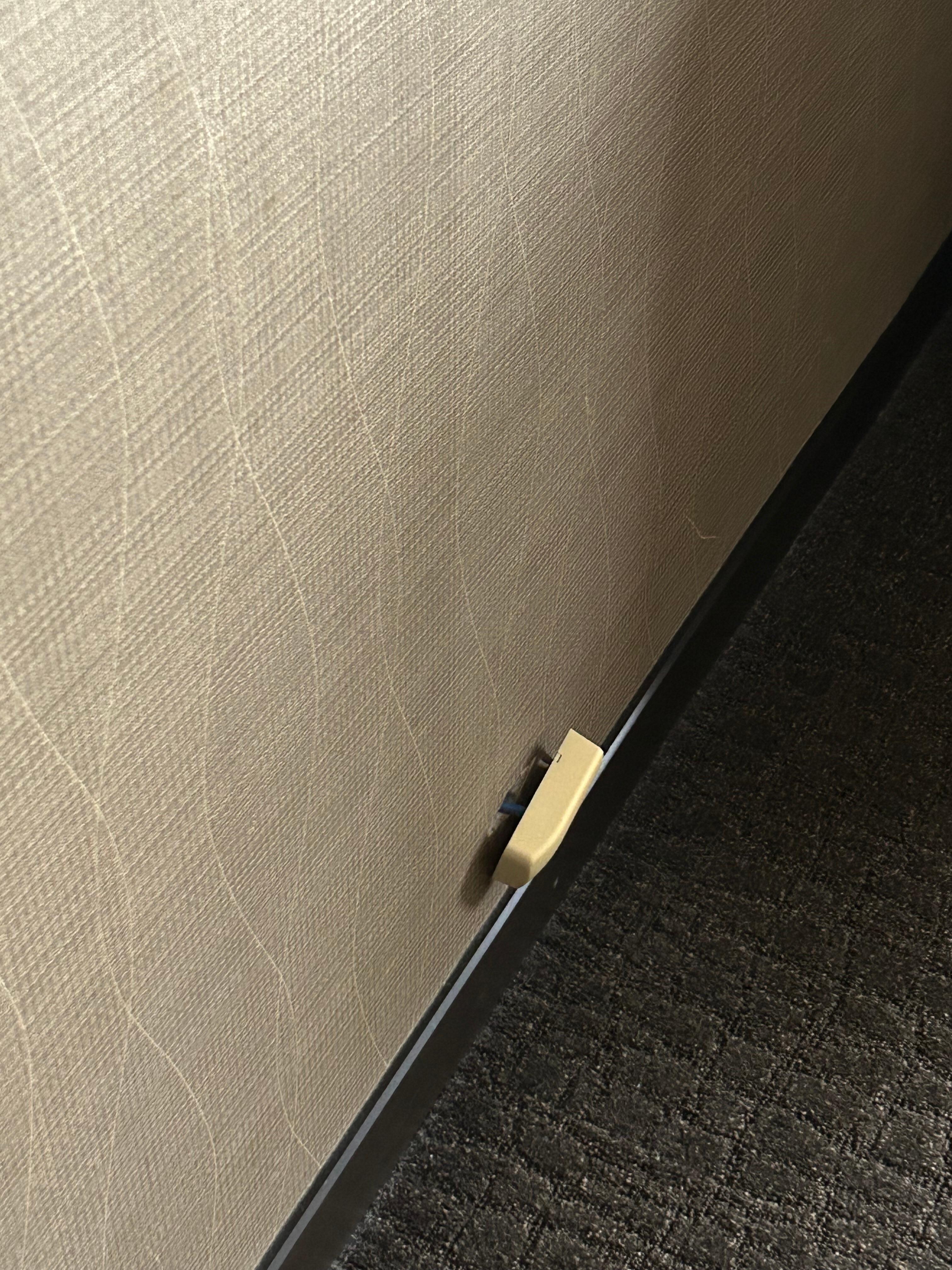 Old phone line connection hanging off the wall