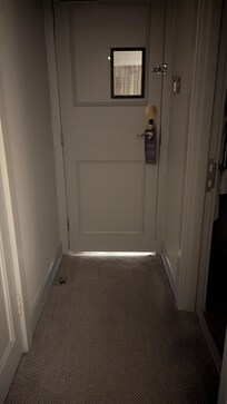 Gap under door allowing in corridor light and noise.