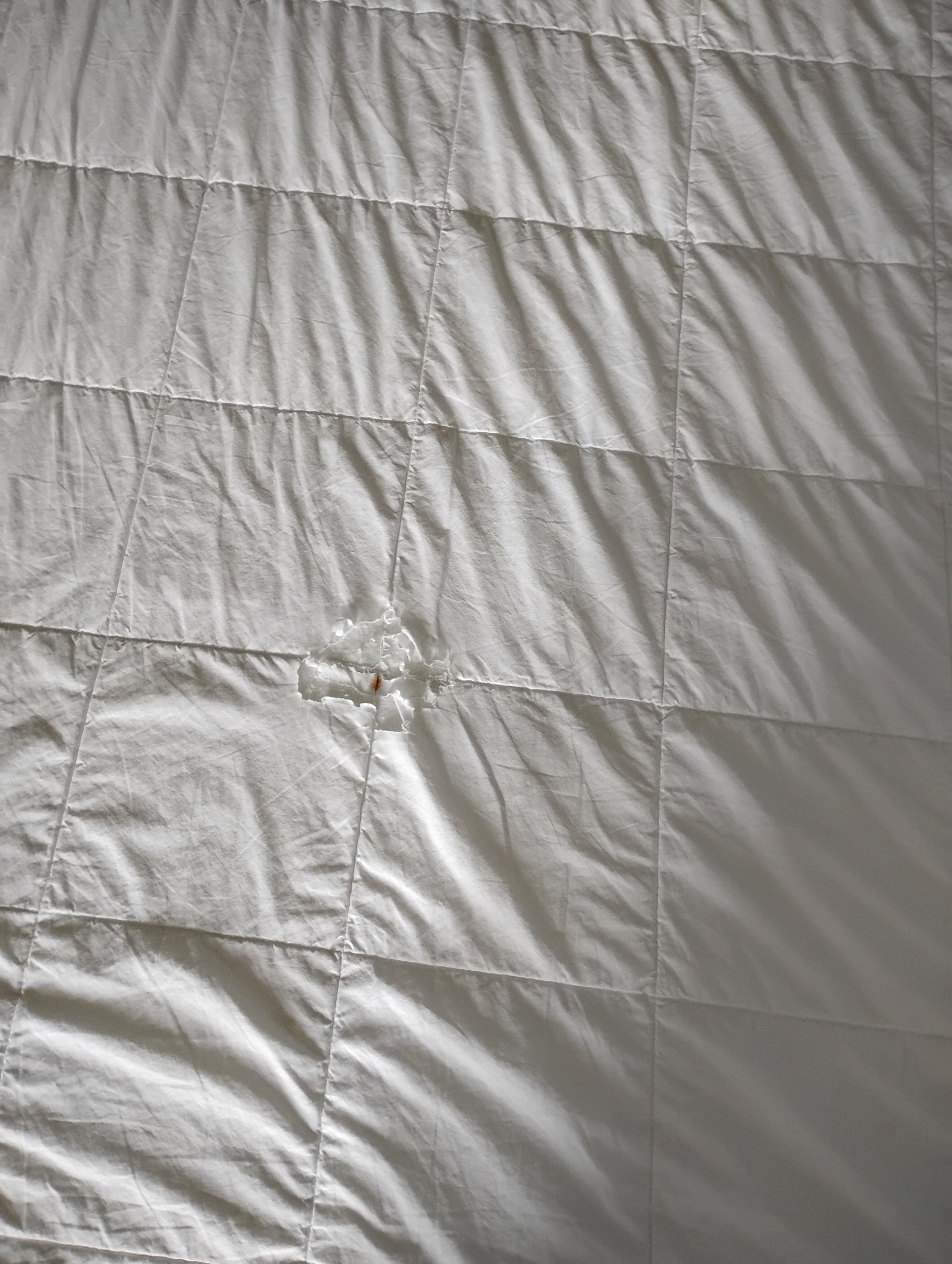 This king size bed was made up and left for us in this manner, with holes in the comforter. This was just the beginning of our terrible experience.