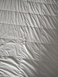 This king size bed was made up and left for us in this manner, with holes in the comforter. This was just the beginning of our terrible experience.