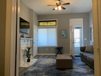 Here is a view of the front living room. There is usually a stylish blue comfy chair in here, too. The door on the right is the front door. There were a few other doors on the main floor that had outside access.