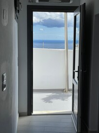 View from inside out onto the patio, where you can see the sea