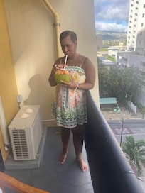 Wife enjoying some refreshing coconut water on our balcony