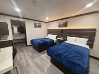 Double bed room; provided a microwave, mini fridge, plastic cups, tub for ice machine, desk area. Multiple plug ins to charge any device.