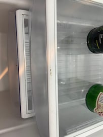 Hair and unknown scum in fridge. A very basic cleaning should have gotten it up