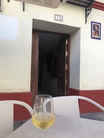 Outside entrance to apartment, close to cafe.