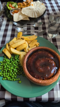 Cumberland sausage, giant Yorkshire, swimming in gravy, chips and peas.