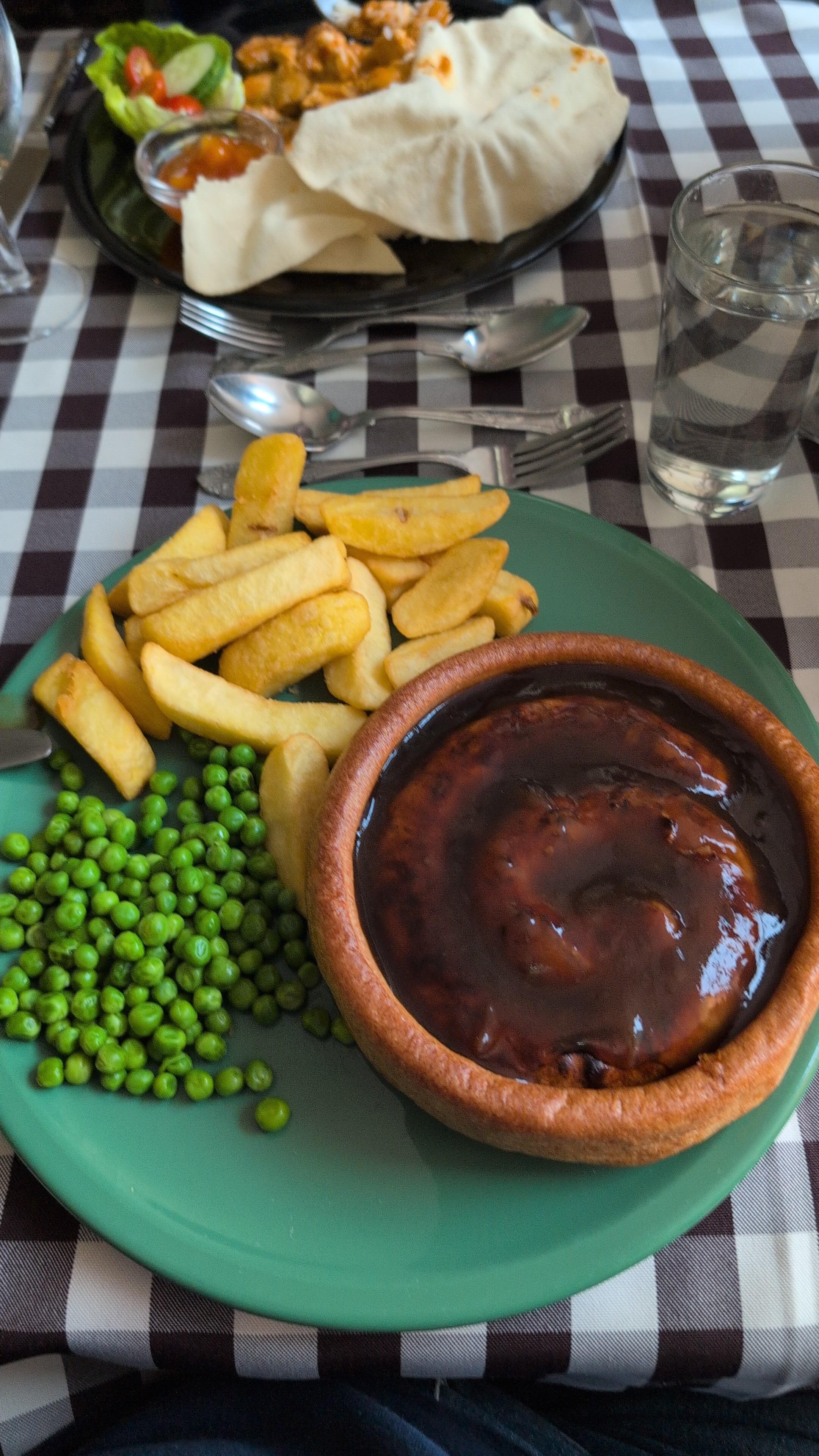 Cumberland sausage, giant Yorkshire, swimming in gravy, chips and peas.