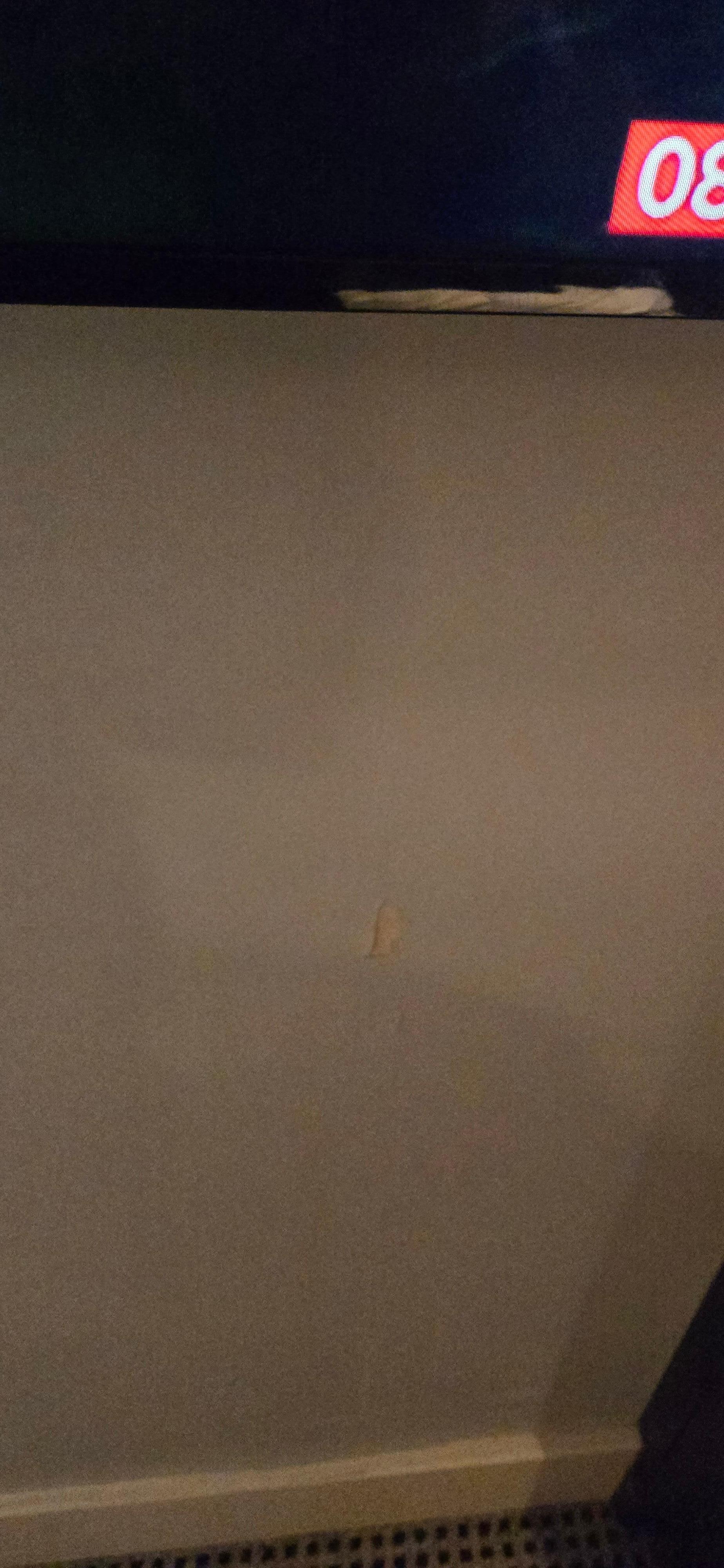 Rip in wall under tv