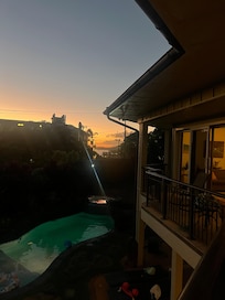 View from lanai of sunset and pool.