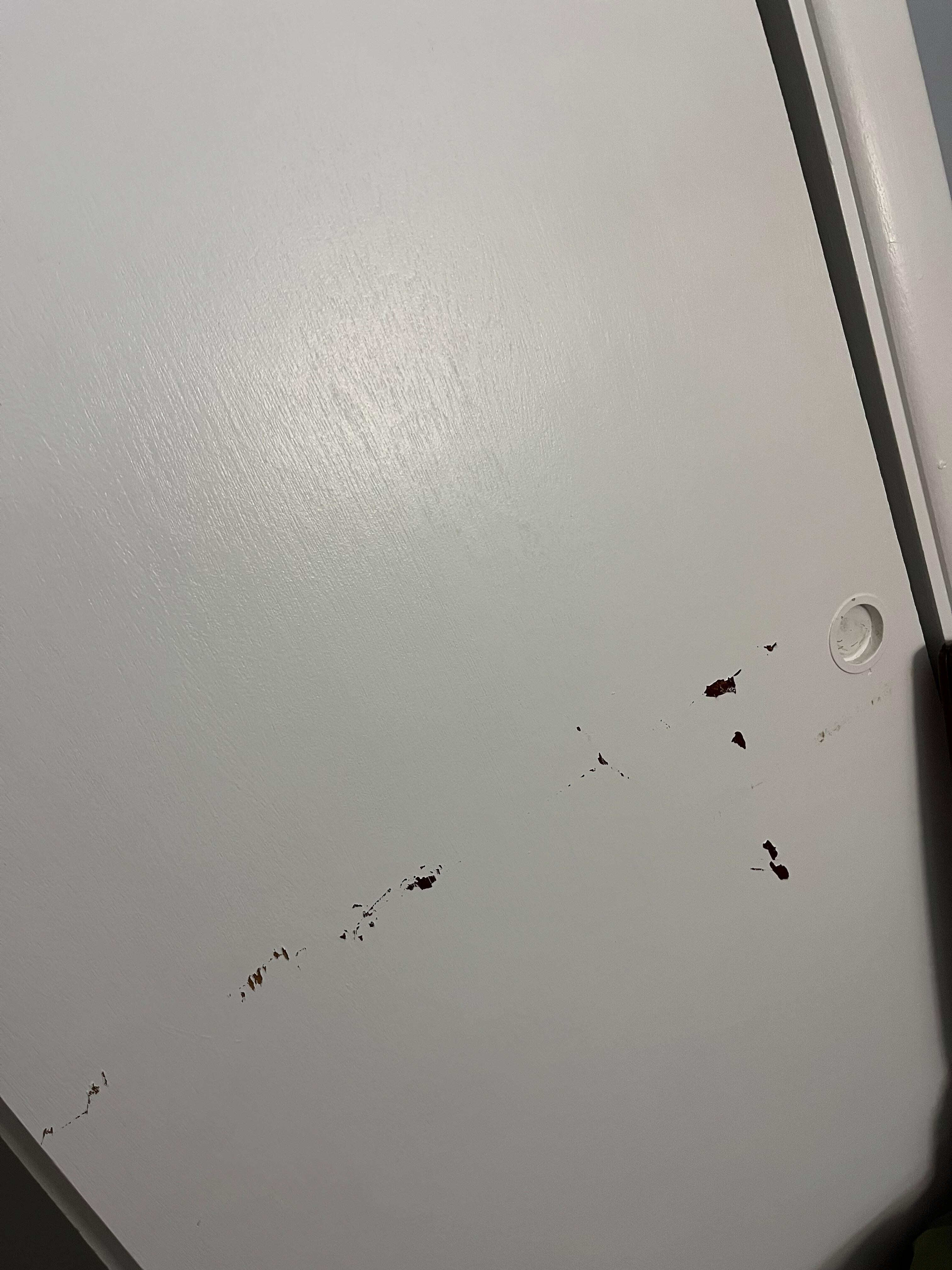Chipped paint on a closet door.