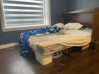 Broken, slanted queen fold out bed against the wall so only one person could get in and out easily.