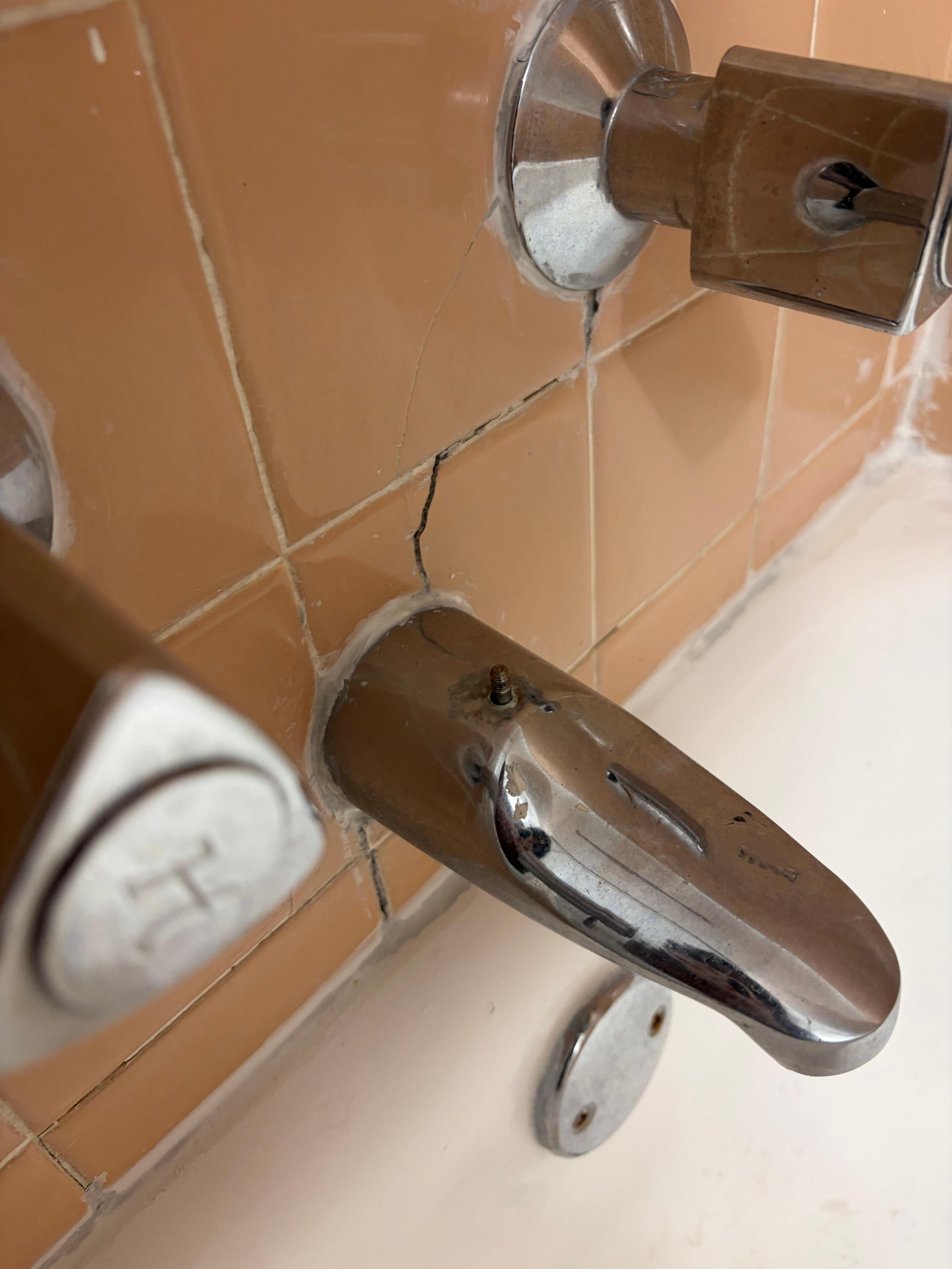 The piece that you would pull up to to shower was missing. There were visible cracks in the tiles. And the showerhead need a cleaning.