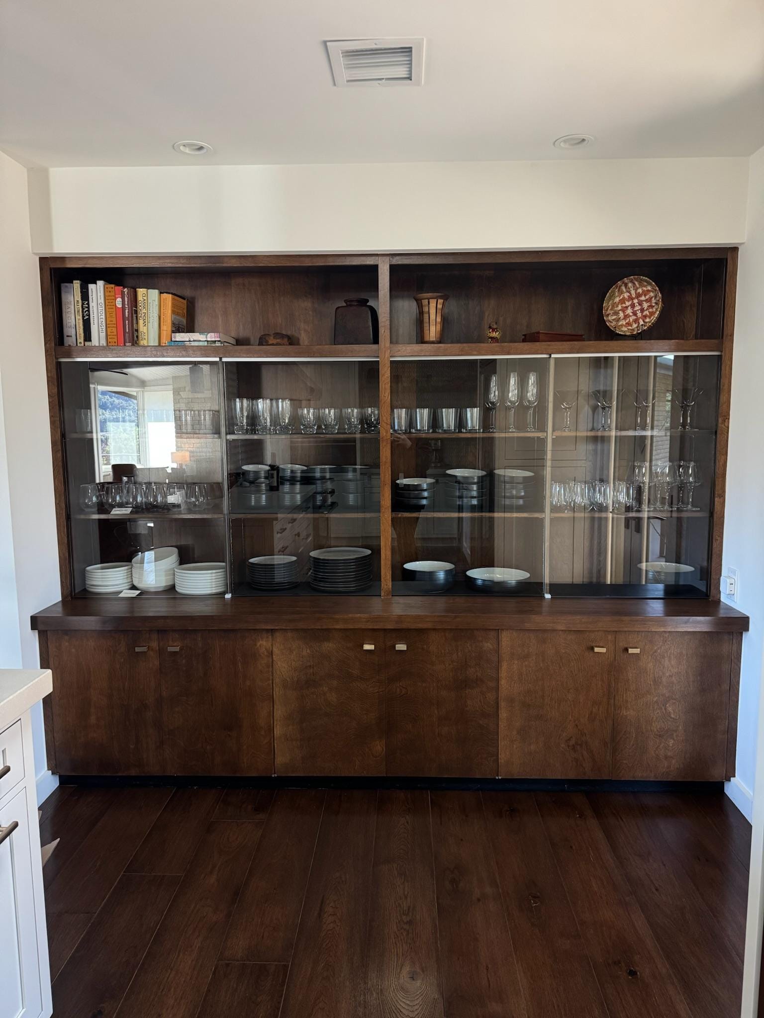 Well-equipped kitchen with upscale appliances, lots of cookware, a variety of spices and utensils, and this heat cabinet which provides great visibility to all the glasses, dishes and serving bowls. 