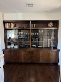 Well-equipped kitchen with upscale appliances, lots of cookware, a variety of spices and utensils, and this heat cabinet which provides great visibility to all the glasses, dishes and serving bowls.