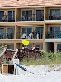 2nd floor balcony with four chairs and a table.