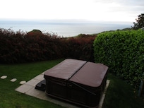 Hot tub-serene, private, yet so close to the sea!