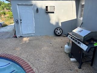 Spare tire by pool, entrance to other apartment