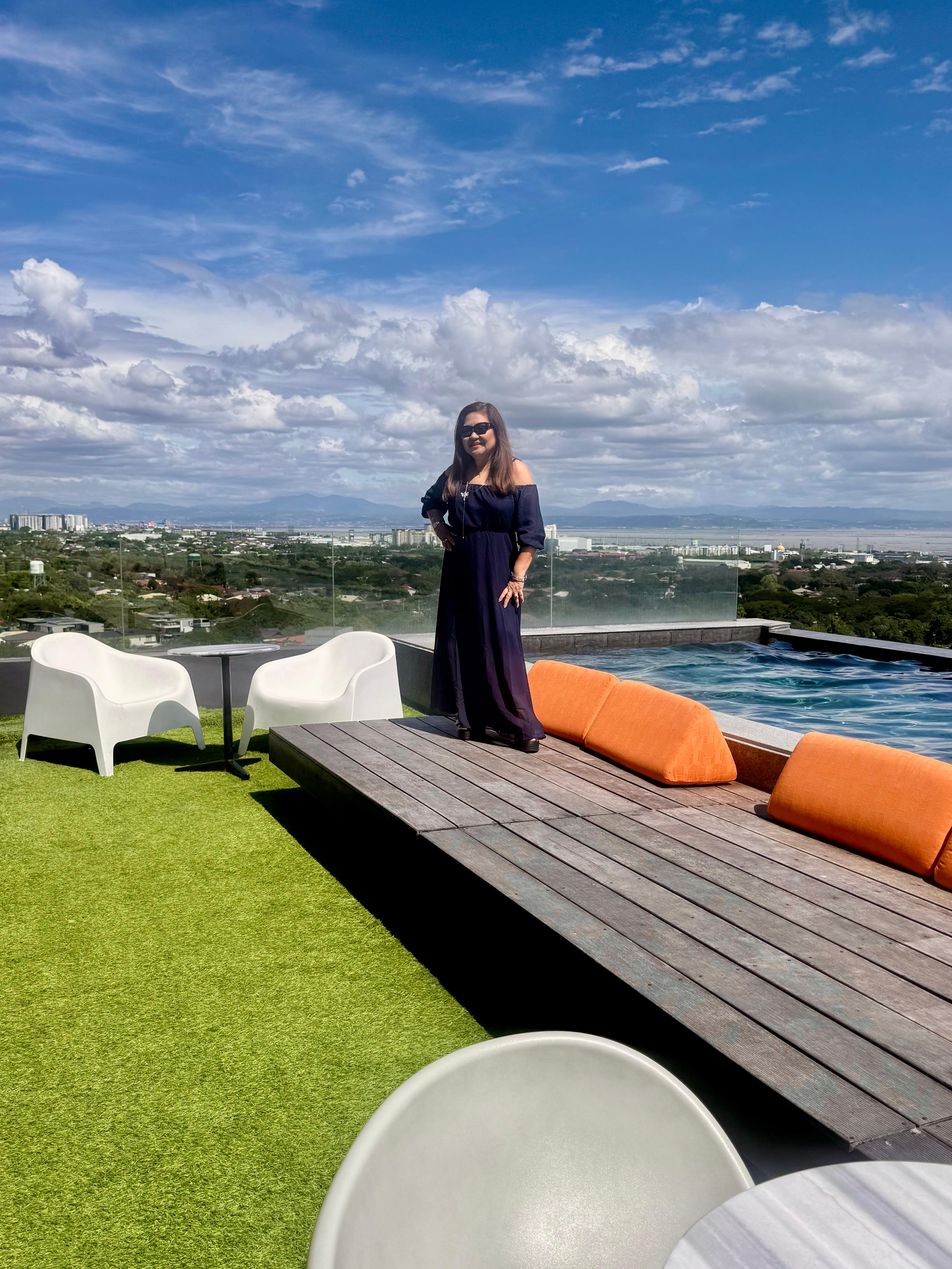 A pose next to  their roof-top infinity pool