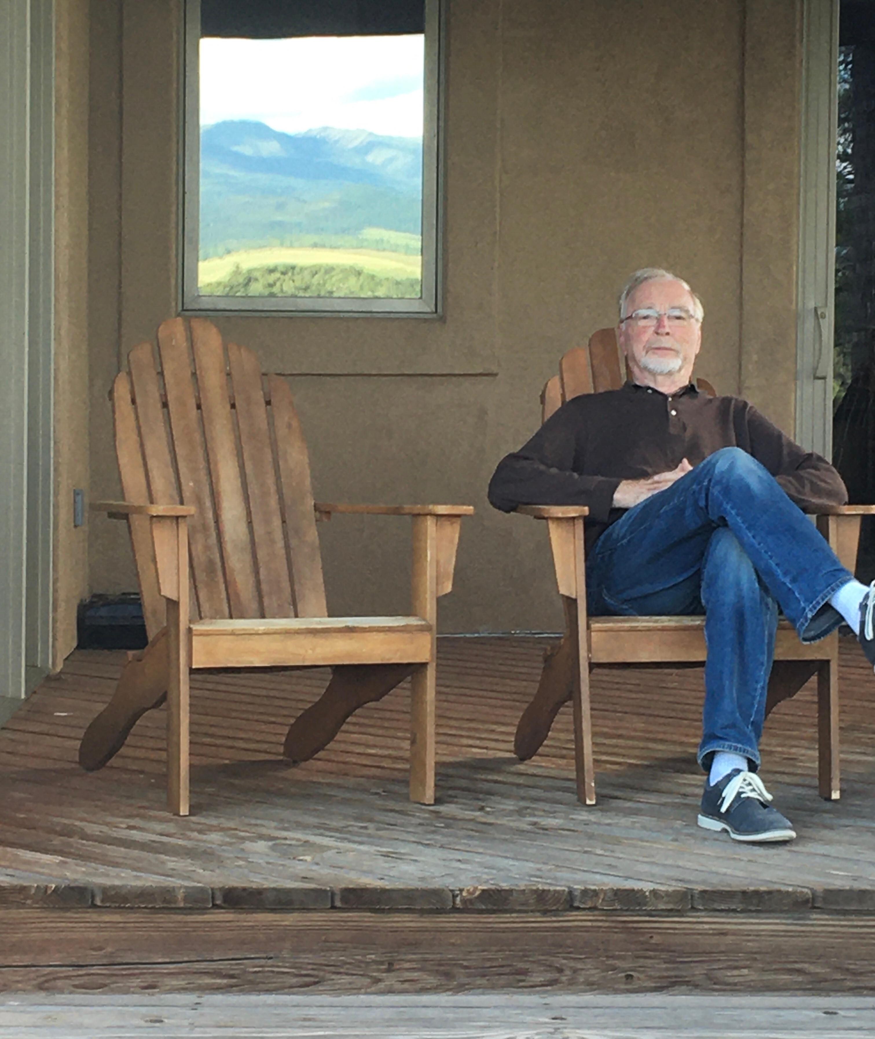 Sitting on the porch. The reflection on the window looked like a painting 
