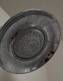 This is what the showerhead look like same situation soap scum they claimed it was hard water