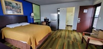 Wide-angle view of room including full-size fridge.