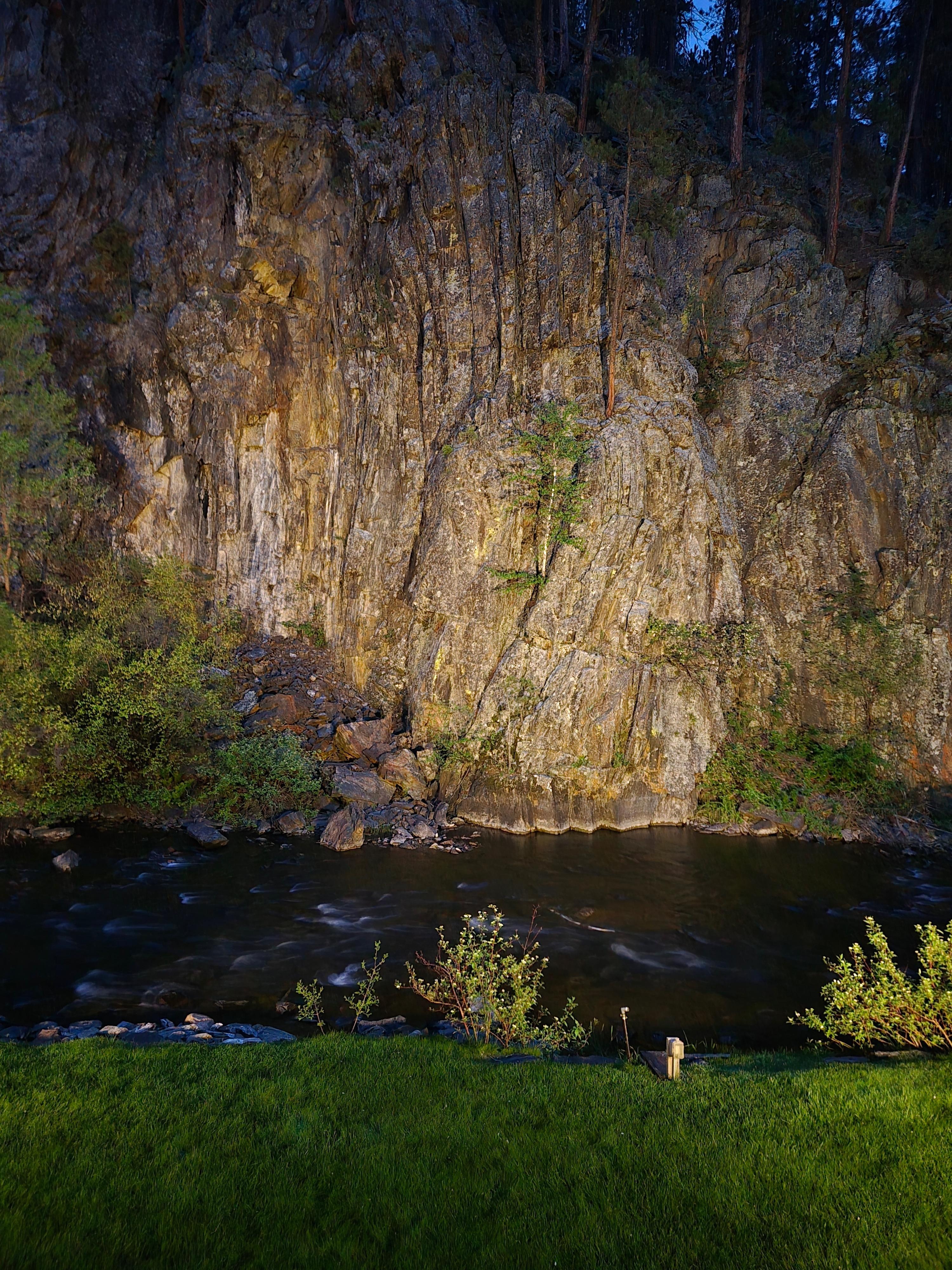 Creek and rock wall at night with spot light