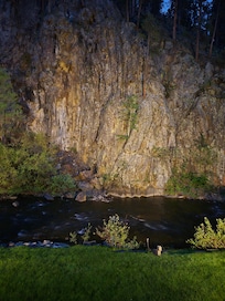 Creek and rock wall at night with spot light