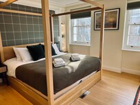 Primary bedroom, with dressing room with four lit closets with built in drawers, desk area, deluxe bath. with steam shower and soaking tub.