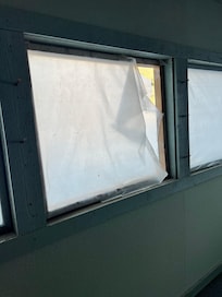 ripped plastic covering "windows" in storm room