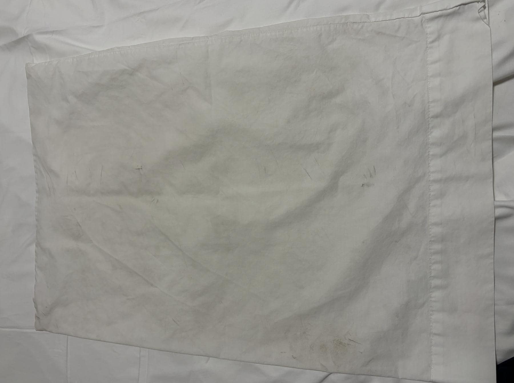 "Clean" pillow case I obtained from cleaning staff tray. Has plenty of black marks on it. 