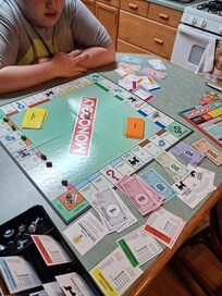 My son kicking my butt at Monopoly.