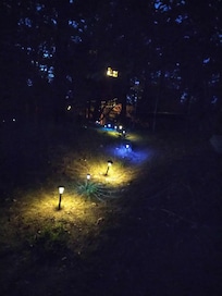 The walkway at night lit up to the left is the hosts house
