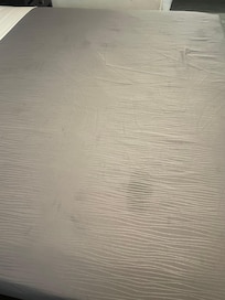 Blanket on bed has spots